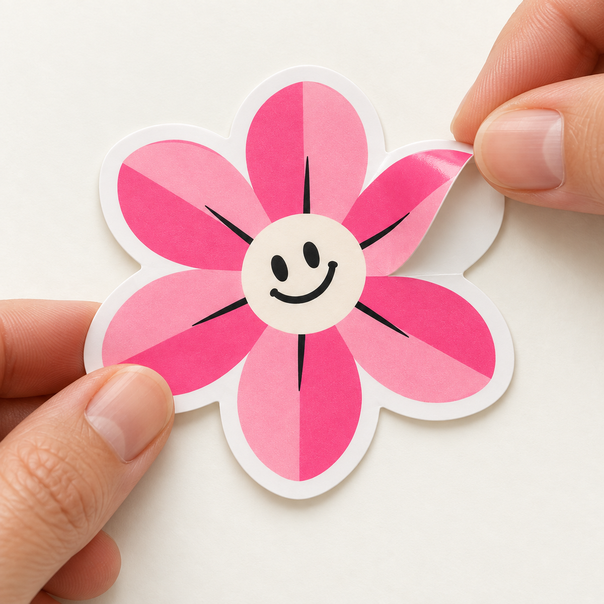 AI-generated illustration: Fingertips gently peel one petal of a pink flower sticker away from its matching flower-shaped release liner.